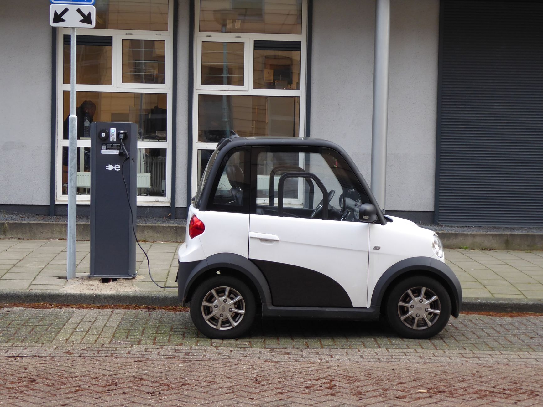 O mașină electrică alimentându-se la o stație publică de încărcare